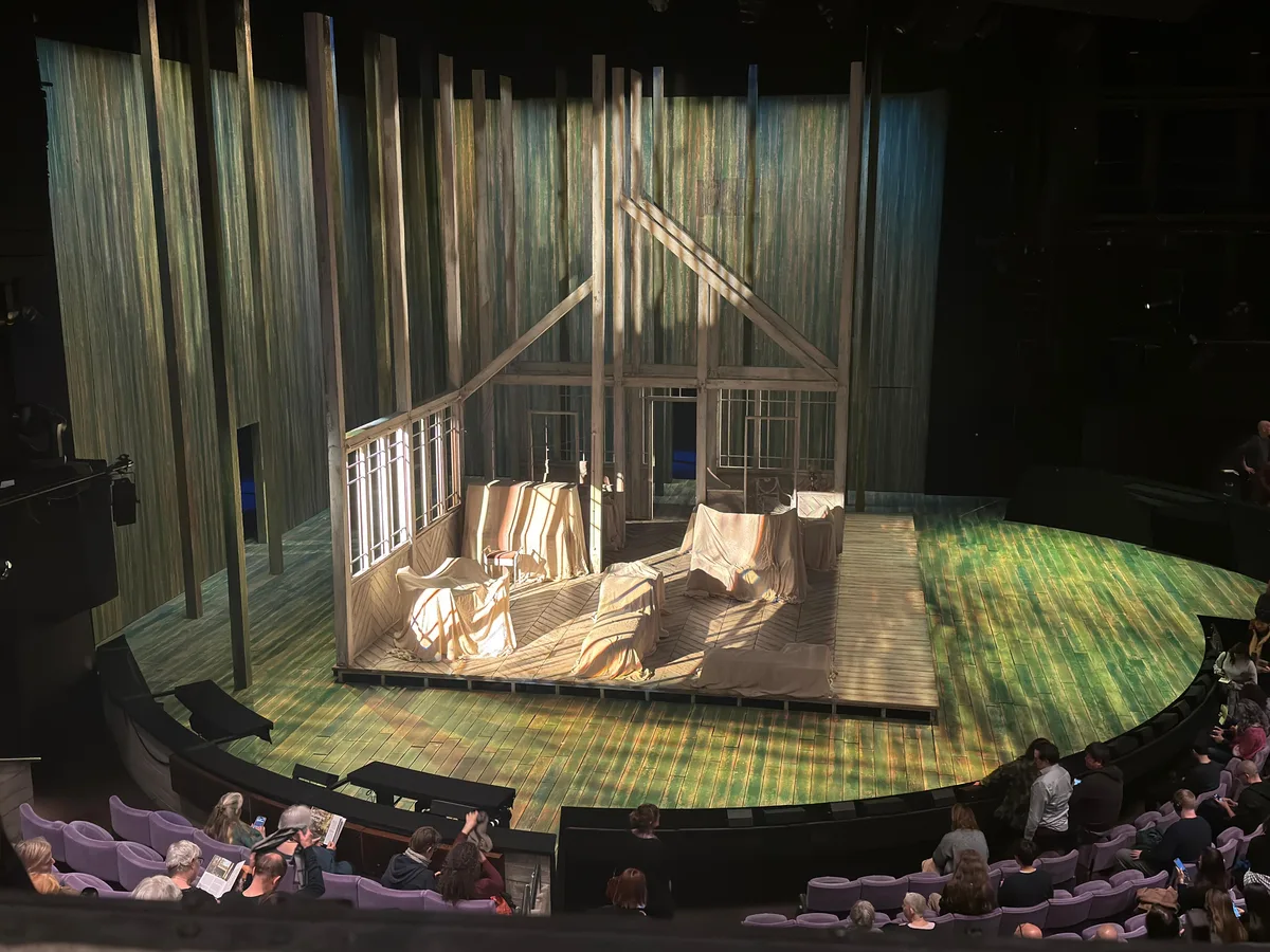 The Summerfolk stage set at the Olivier Theatre - a skeletal dacha frame surrounded by hanging birch-bark curtains